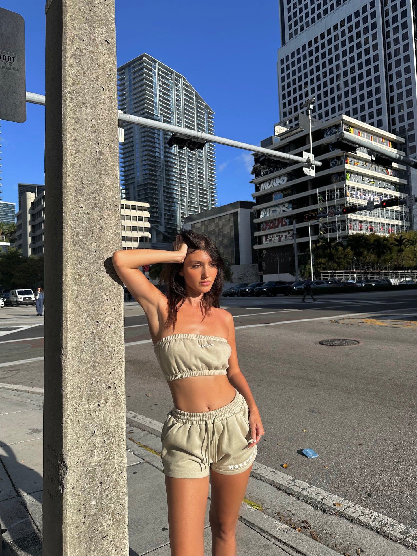 honeydew lounge girl wearing oversized lounge shorts and sweatshirt bandeau top
