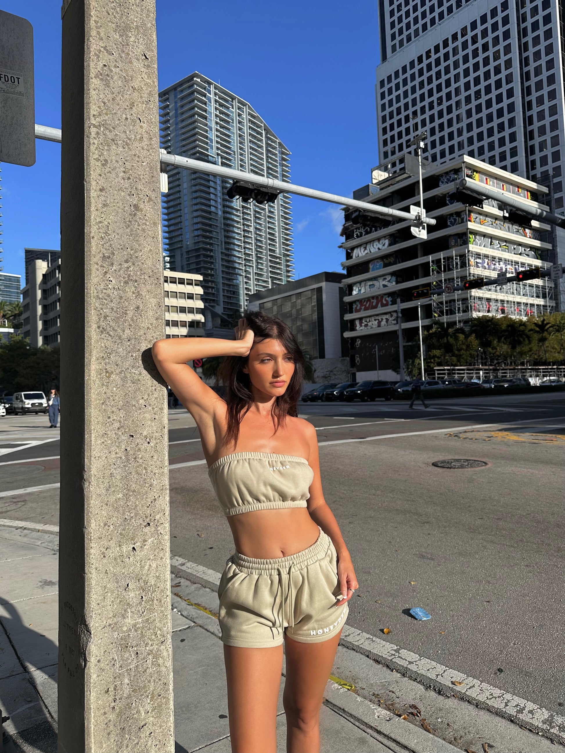honeydew lounge girl wearing oversized lounge shorts and sweatshirt bandeau top
