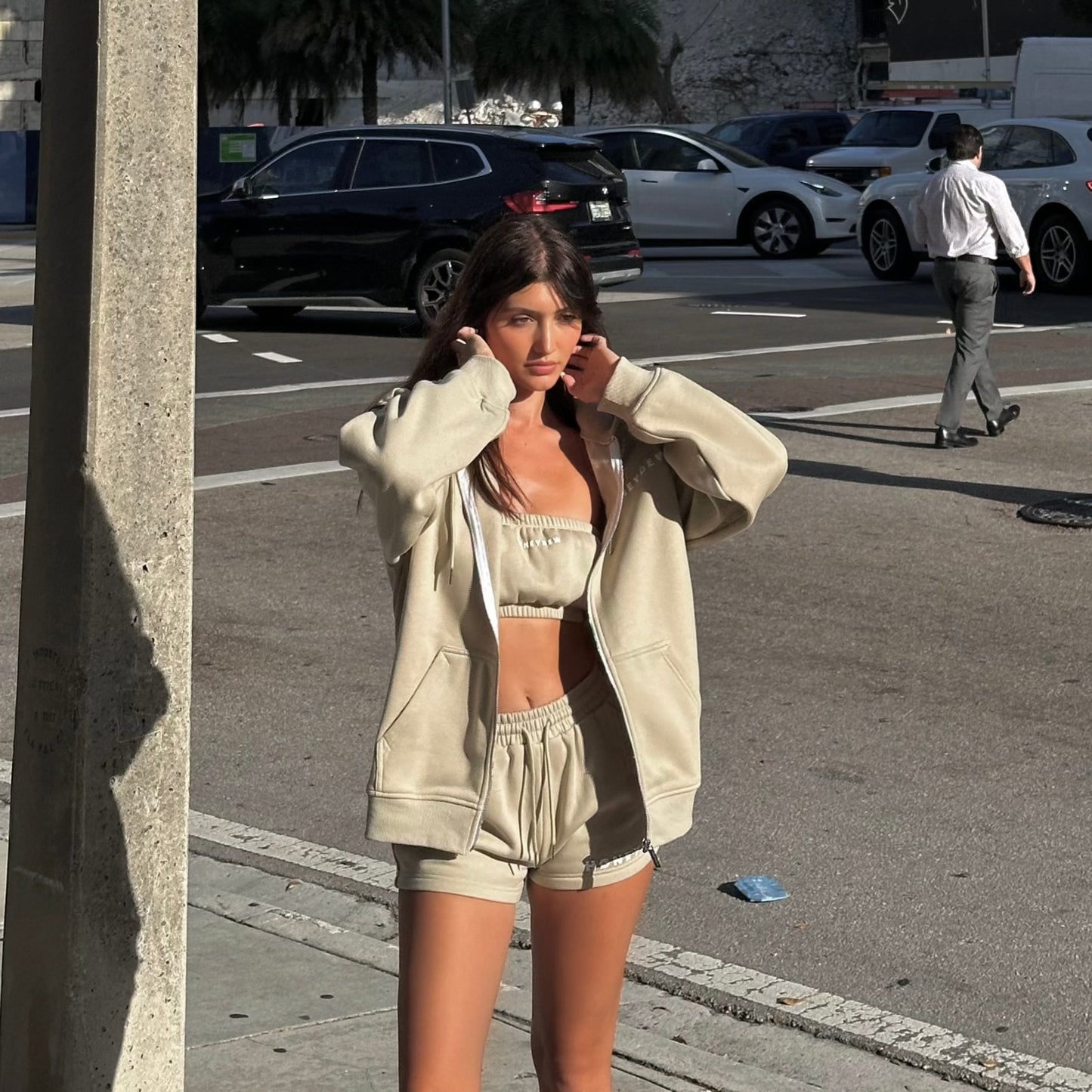 honeydew lounge girl wearing oversized girly sweatshirt with lounge shorts and bandeau top