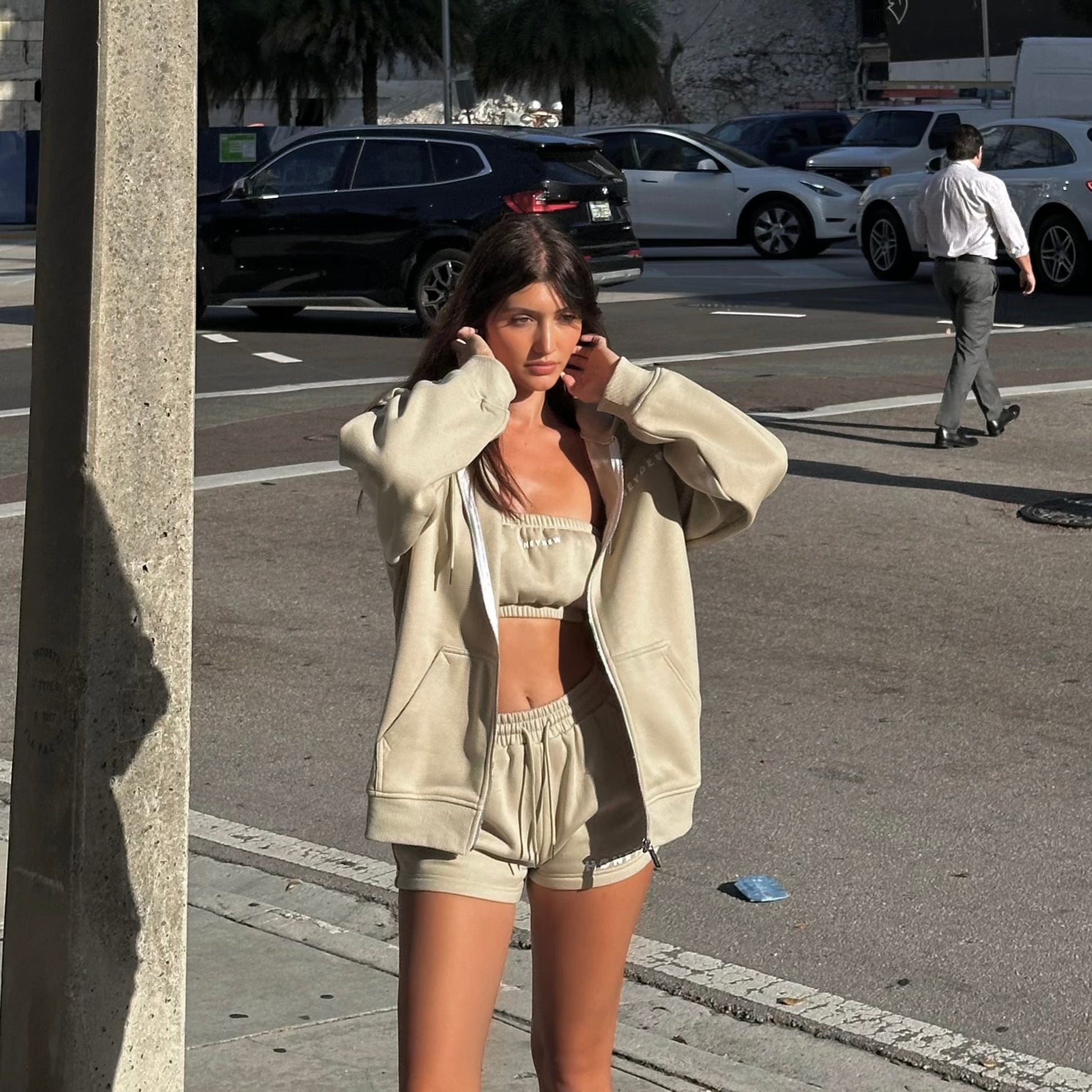 honeydew lounge girl wearing oversized girly sweatshirt with lounge shorts and bandeau top