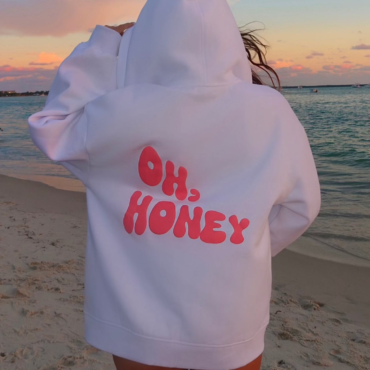 honeydew lounge girl wearing cute girly oversized hoodie on the beach