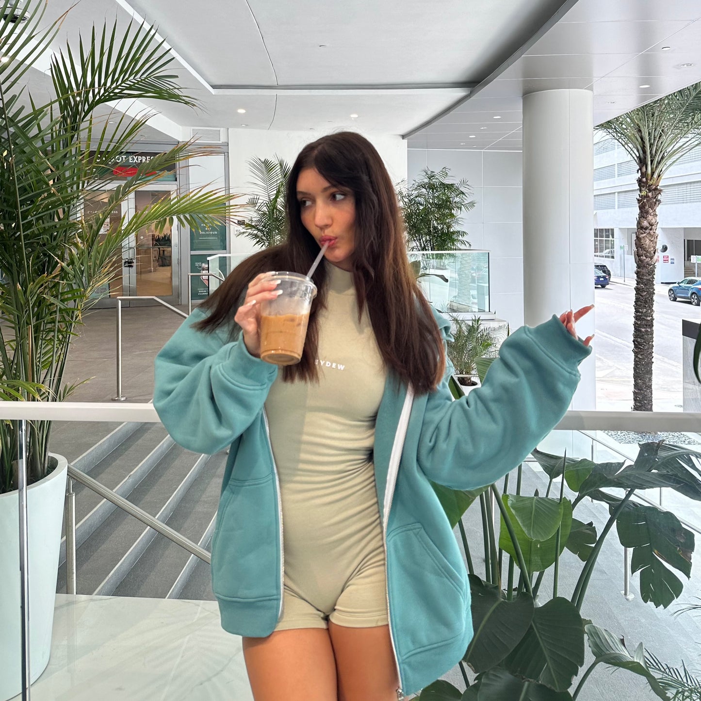 honeydew lounge girl wearing high neck onesie playsuit and oversized cute sweatshirt