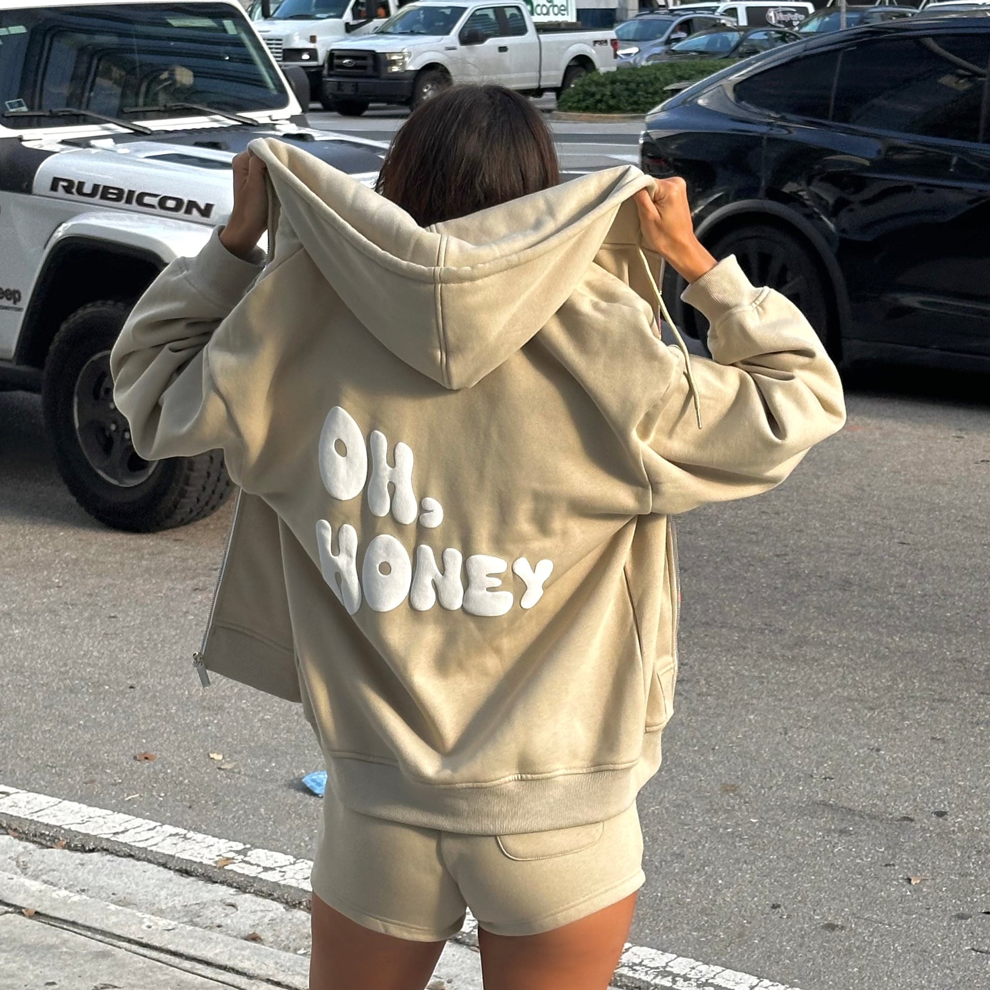 honeydew lounge girl wearing cute girly oversized hoodie that says oh honey