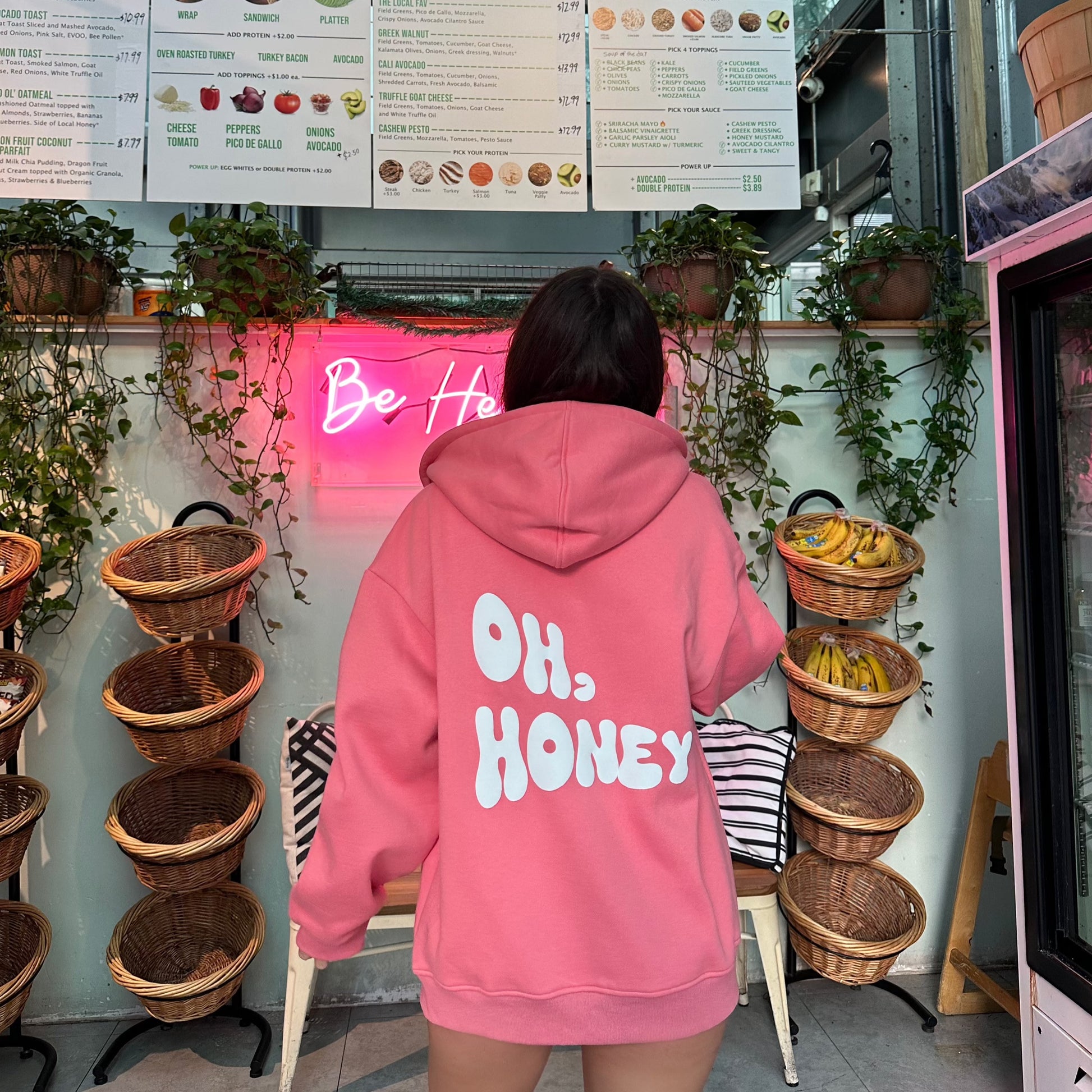 honeydew lounge girl wearing cute girly oversized hoodie that says oh honey