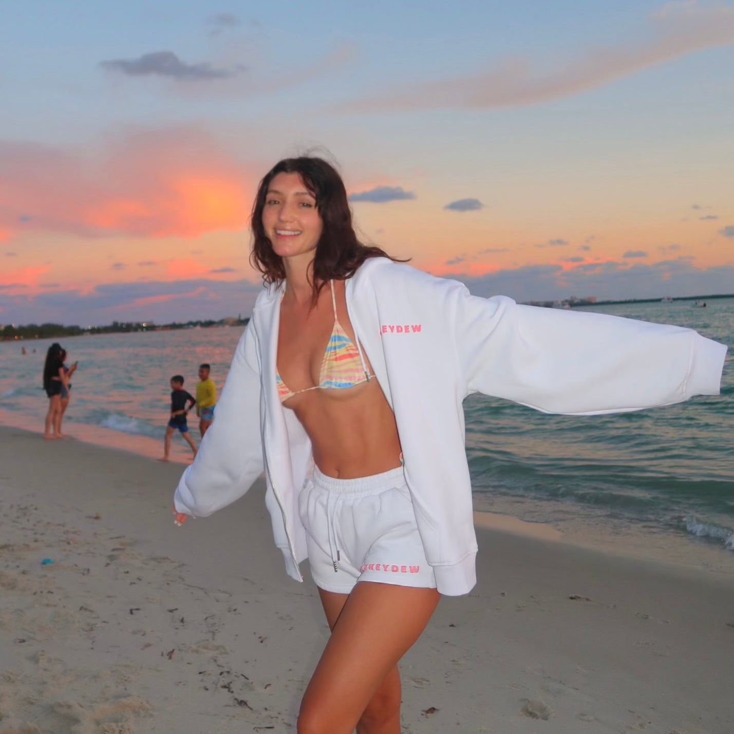 honeydew lounge girl wearing cute oversized hoodie on the beach with oversized sweat shorts